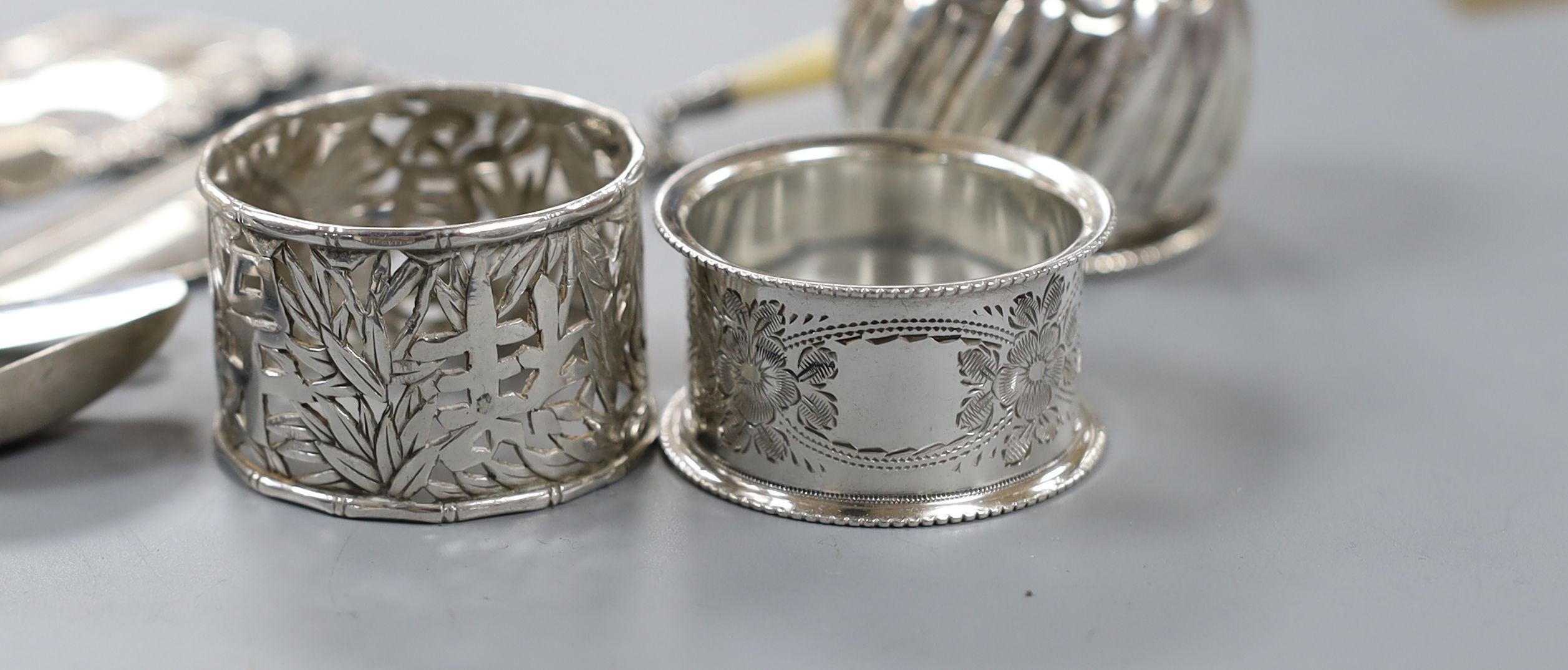 A quantity of small silver cutlery, a pair of silver decanter labels, Sherry and Whisky and eight various silver serviette rings.